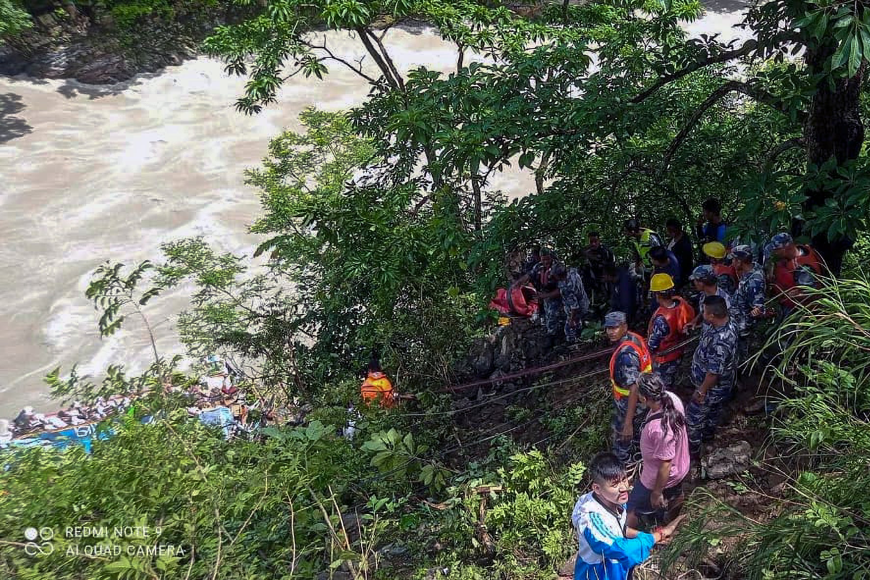 This photograph provided by Nepal Armed Police Force (APF) shows APF personnel carrying out rescue operation after a bus carrying Indian pilgrims fell into a river near Abukhaireni town, about 75 miles west of the capital, Kathmandu, Nepal, Friday, 23 Aug 2024. (Nepal Armed Police Force via AP)